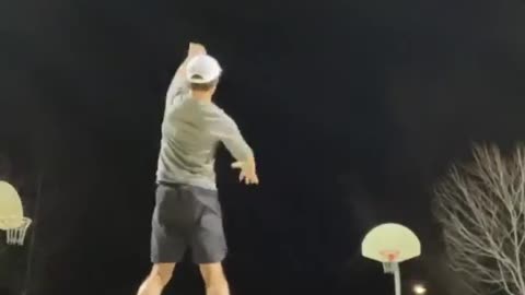 Guy Makes Impressive Basketball Trickshot From Half Court While Balancing on Two Balls