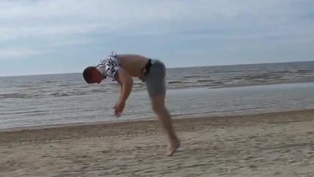 Guy Performs Multiple Consecutive Flips and Split on Beach