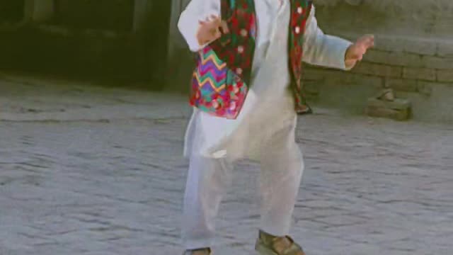 Kid plays in village