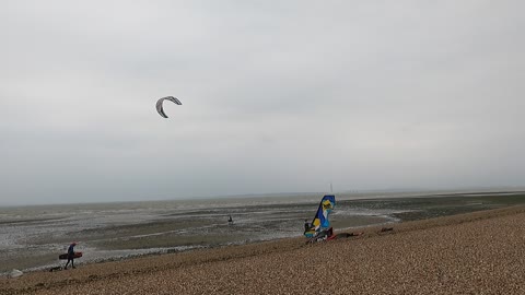 An there he goes . Kite surfing.