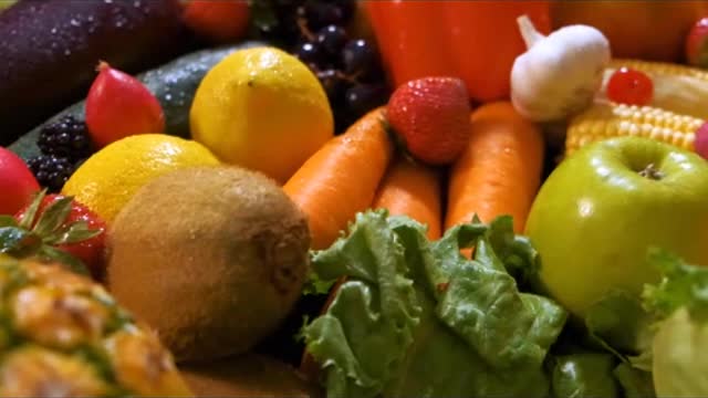 Surface covered with many fruits and vegetables seen in detail