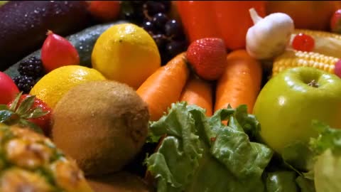 Surface covered with many fruits and vegetables seen in detail