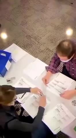 POLL WORKERS CLEARLY FILLING OUT BALLOTS