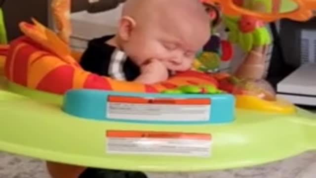 Tired baby literally falls asleep while bouncing in jumper