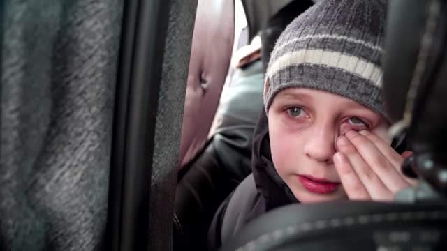 'We left our Dad in Kyiv' -little boy chokes back tears