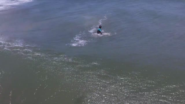 Hokkaido｜A drone shot a surfer from above on a beach in Japan