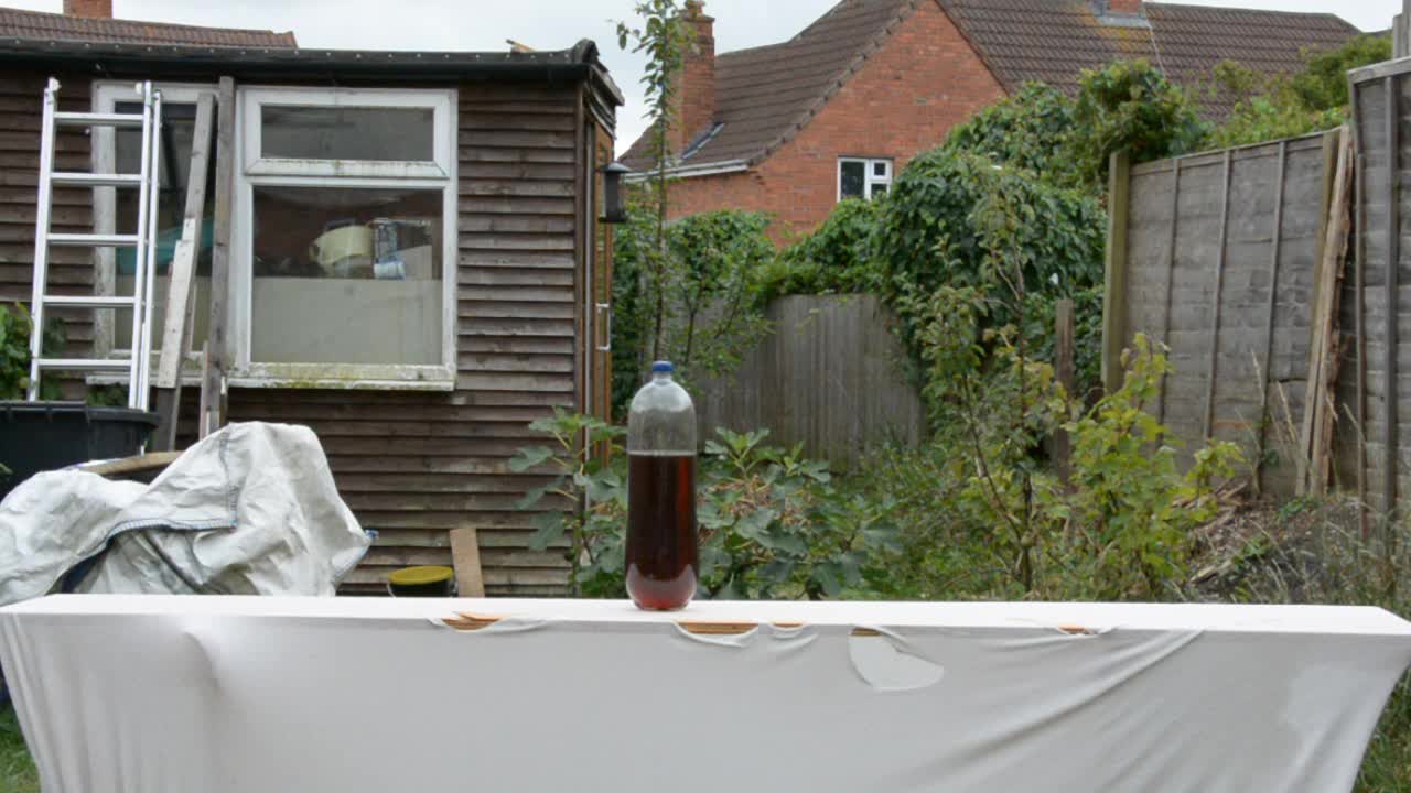 Cutting a bottle of homemade beer. Quite funny.