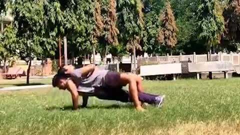 Bodybuilder Performs Planks and Push-Ups With Additional Weight of Man on His Back