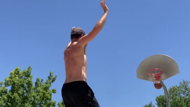 Guy Makes Three Consecutive Basketball Trickshots While Balancing Himself Over Slackline