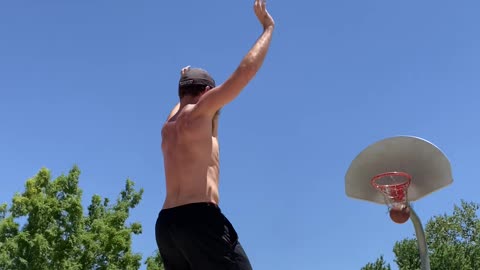 Guy Makes Three Consecutive Basketball Trickshots While Balancing Himself Over Slackline