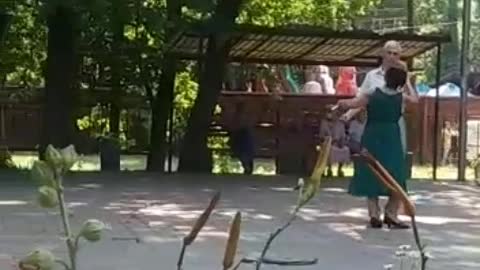 Retired men and women dancing in Kyiv park, Ukraine