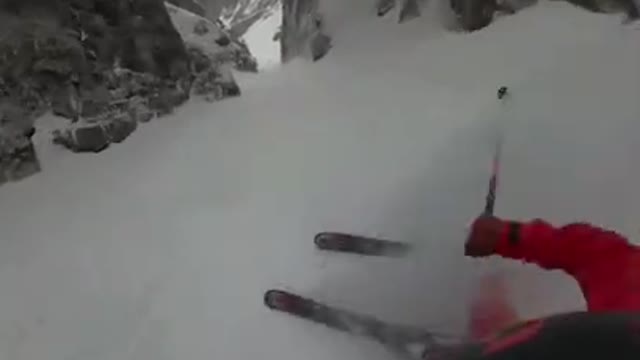 Guy Skis Down Steep Mountain Slope at High Speed