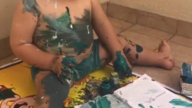 Artistic toddler makes a gigantic mess with watercolors