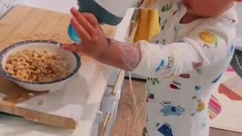 Toddler Spills Milk on the Floor While Trying to Pour it Into Bowl of Cereal