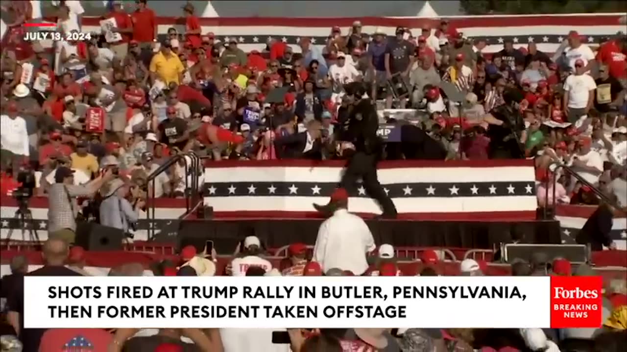 BREAKING_NEWS__Shots_Fired_At_Trump_Rally,_Former_President_Pumps_Fist_As_He_s_Rushed_Off_Stage(480p