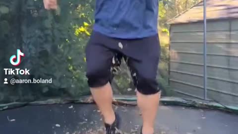 Fat guy jumping on a trampoline I'm slow mo