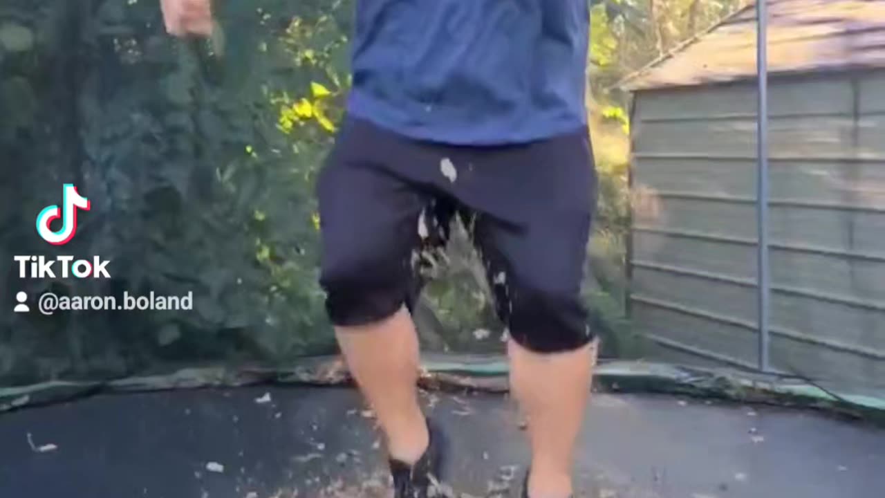 Fat guy jumping on a trampoline I'm slow mo