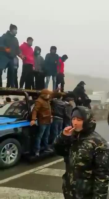 Footage from Almaty, police, along with protesters, move in the city center