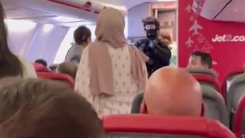 Armed Police escort perpetrators off flight