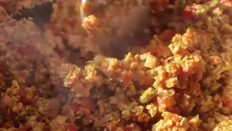 Person Cooks Delicious Indian Combination of Minced Meat With Bread