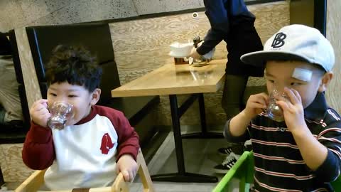 Adorable toddlers toast each other