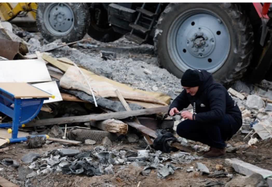 In pictures: Friends embrace after heavy bombardment hits Kyiv