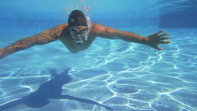 Swimming underwater in a pool