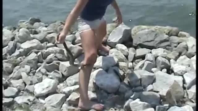 Girl Being Bitten by Aggressive Water Snakes