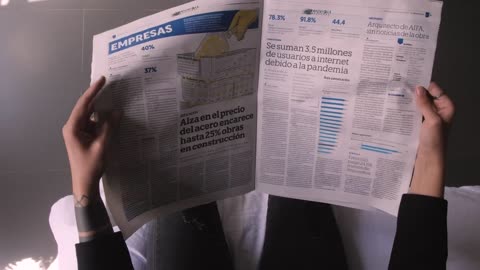 POV flipping through a newspaper