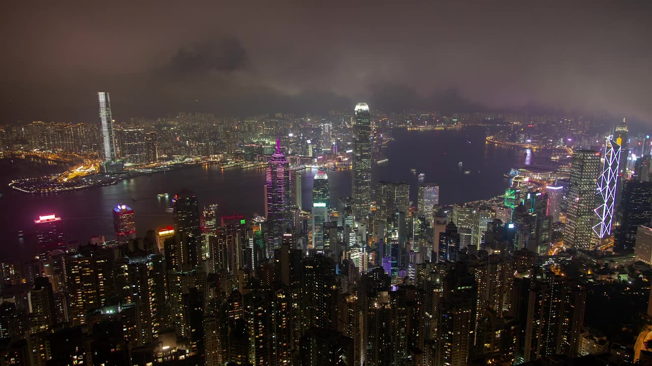 City of huge buildings with a river at night