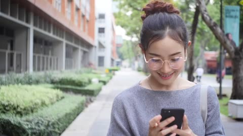 Pritty Asian girl looking at the phone