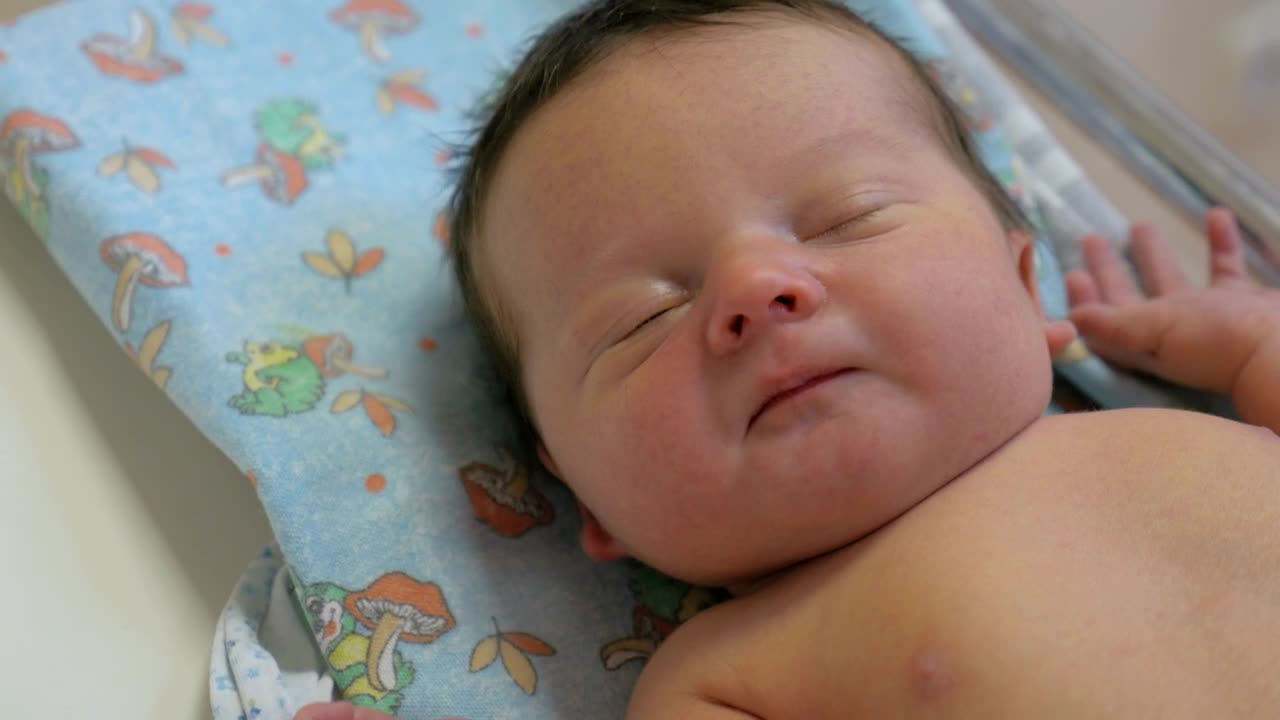 Lifting a baby from a mat