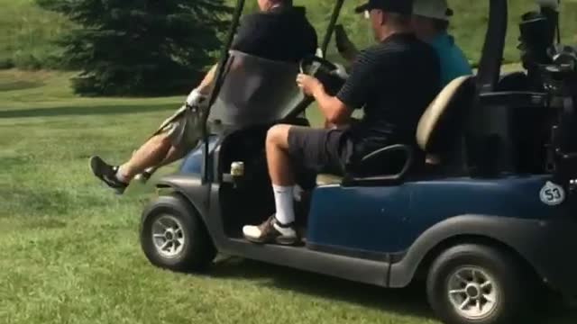 Golfer black shirt hit by golf cart breaks windshield angle 2