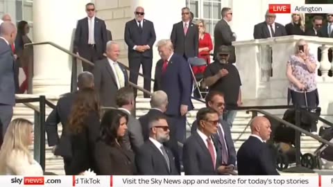 President Trump touches the wreath at Arlington.