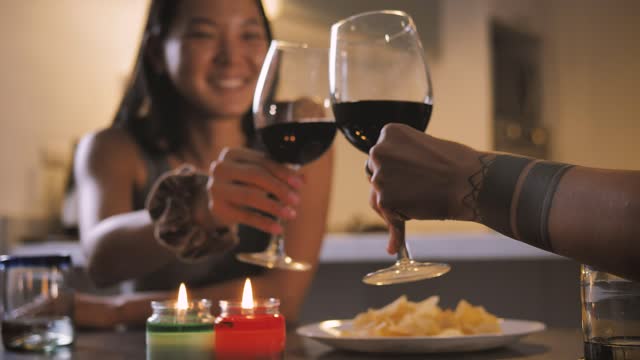 Couple of women making a toast during a dinner