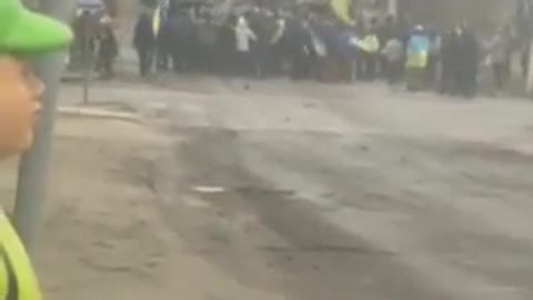 Civilians waving Ukraine flags, block the advance of the Russian army