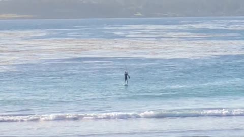 Man in distance paddle boarding