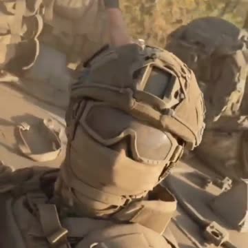 Russian soldiers driving through a dusty road somewhere in the SMO zone