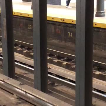 Brown jacket white shoe guys dances in subway terminal