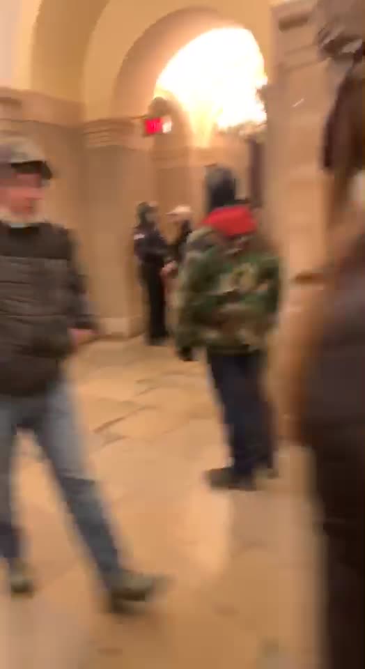 Police watch quietly and issue no violation warnings inside the Capitol on Jan 6: Brandon Fellows cell phone video