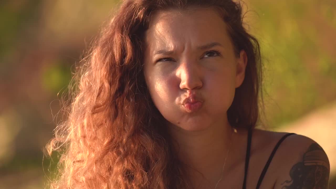 Charming young girl is making cheerful face