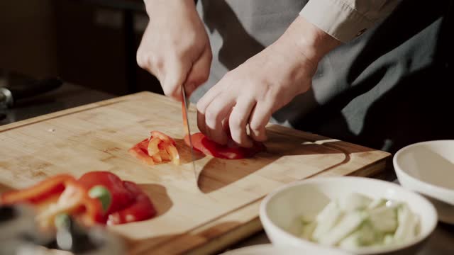 Cheif Slicing a Red Chilli with a Knife
