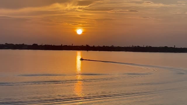 Boat on Sunlit Water