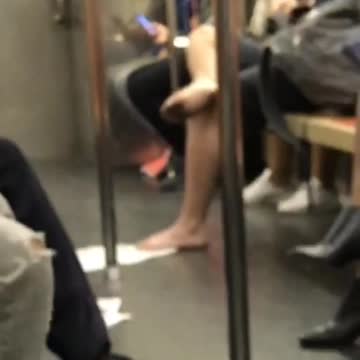 Barefoot man with dirty feet on subway