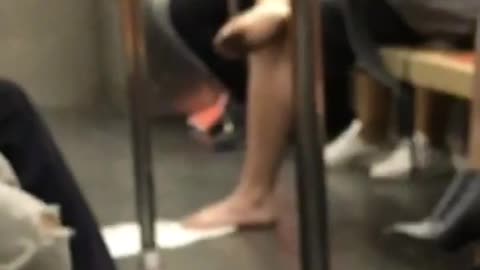 Barefoot man with dirty feet on subway
