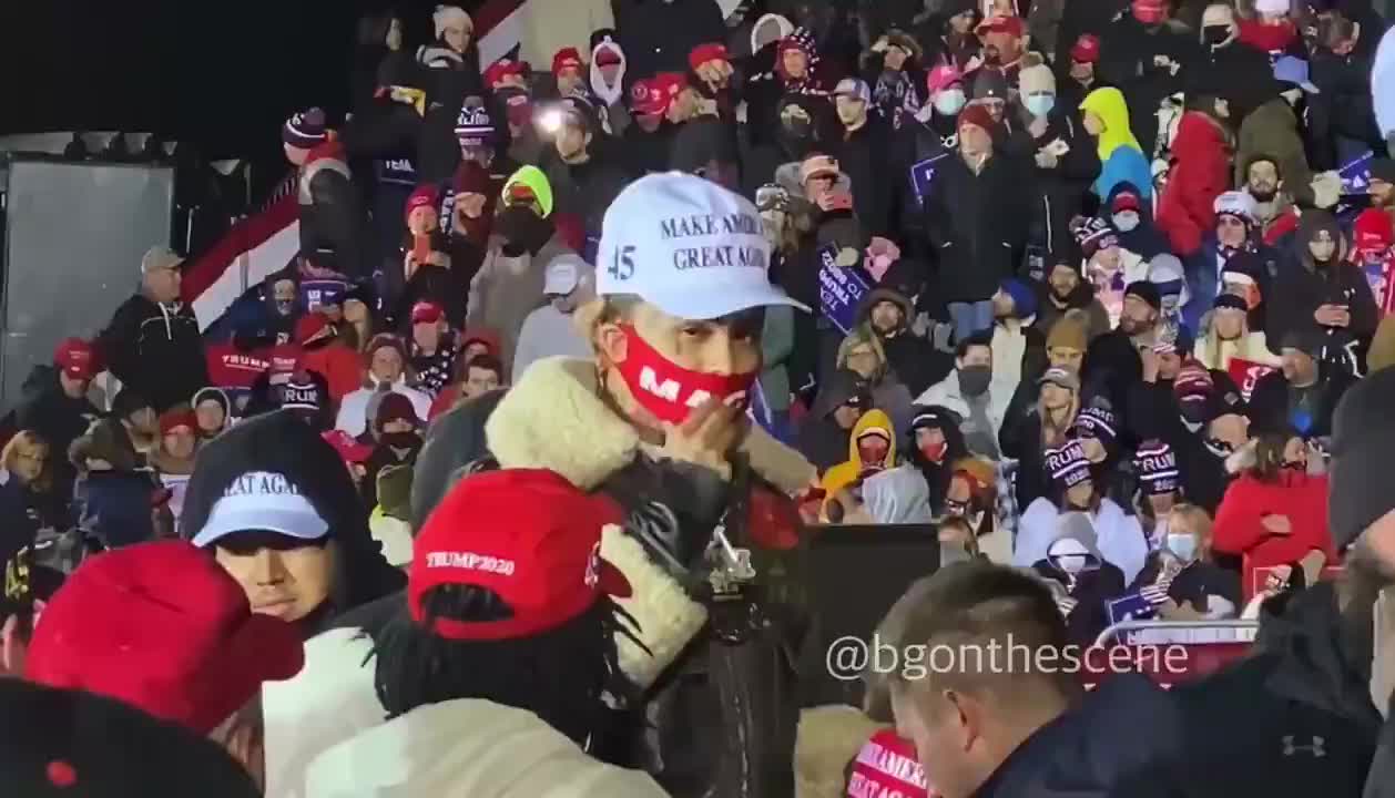 Lil Pump passes out maga hats at a rally.