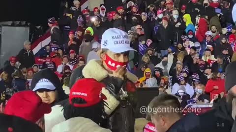 Lil Pump passes out maga hats at a rally.