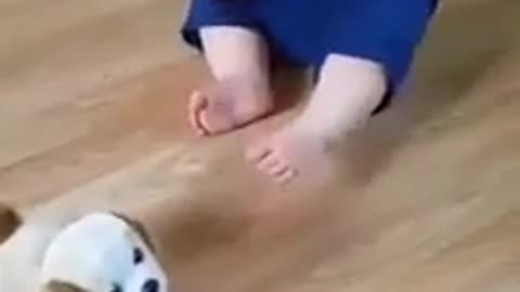 baby laughing with jumping dog
