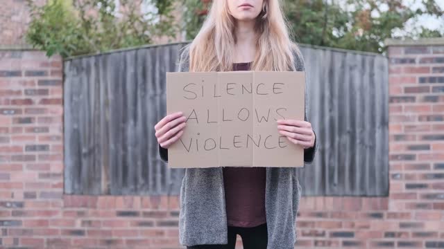 A Woman Holding a Placard