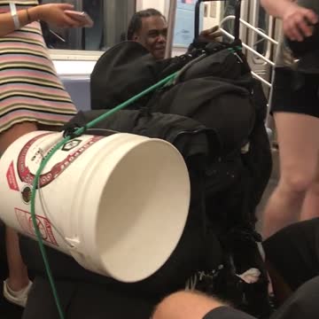 Three girls singing on empty subway train